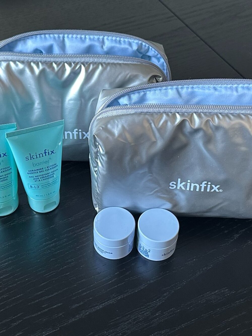 New pair Skinfix silver cosmetics pouches w mini Gel Cleansers & Water Creams